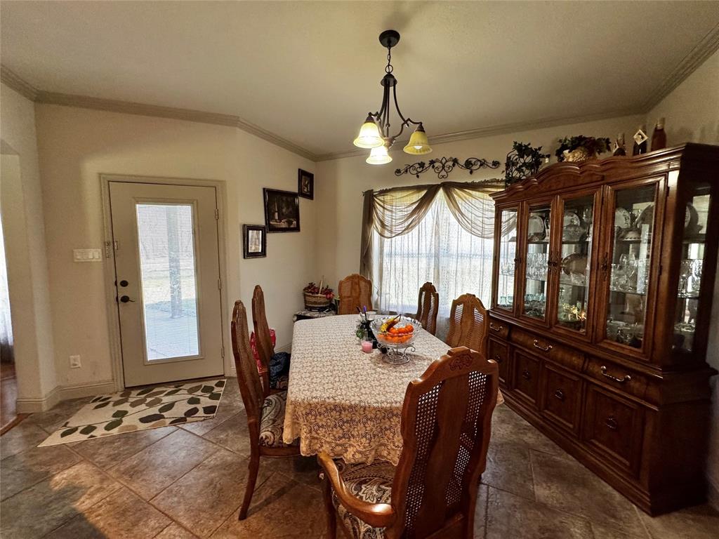 121 Rey Del Mar Circle Weatherford, TX 76085 - Photo 10 of 29 a dining room with furniture a chandelier and window