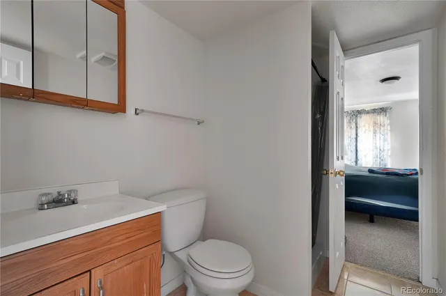 a view of an empty room with wooden floor and a cabinet
