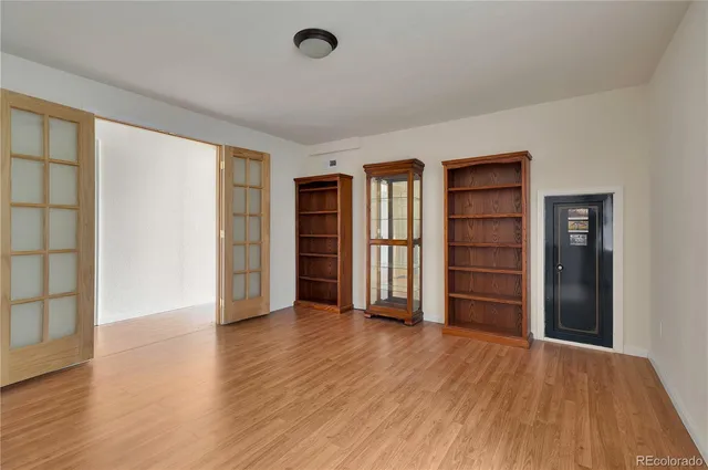 a kitchen with a sink dishwasher and cabinets with wooden floor