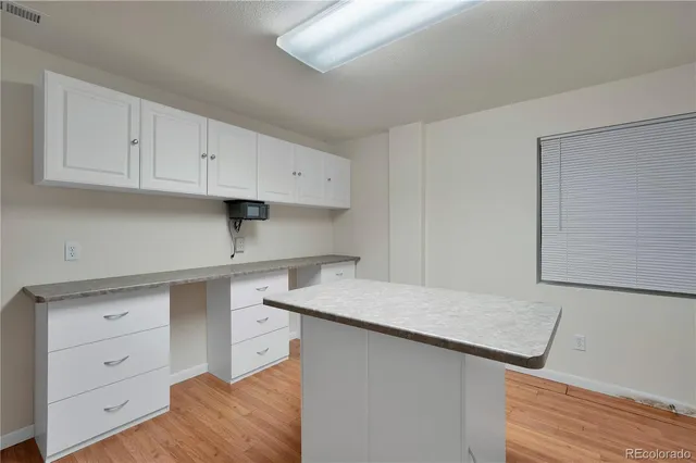 a balcony with wooden floor and fence