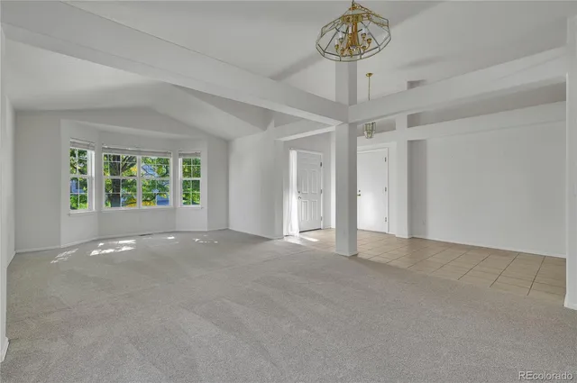 a kitchen with kitchen island a dining table and chairs