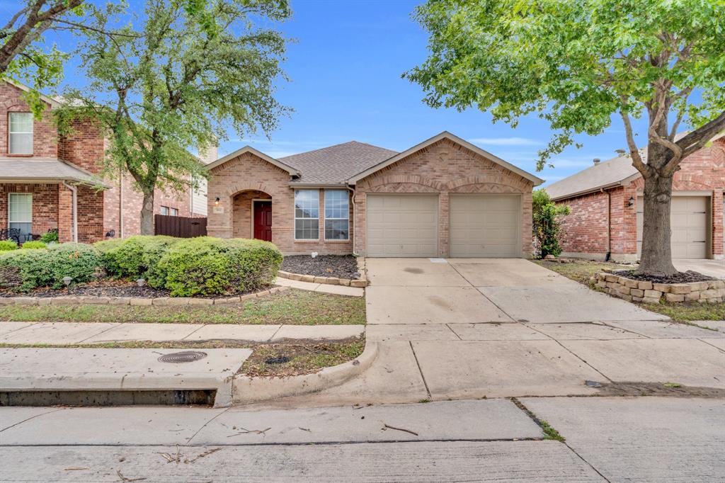1012 Morris Ranch Court Forney, TX 75126 - Photo 1 of 1 View of front facade featuring concrete driveway, brick siding, roof with shingles, and a garage