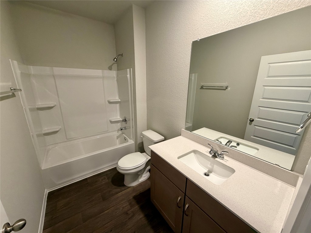 117 Rocky View Lane Georgetown, TX 78628 - Photo 13 of 17 a bathroom with a sink toilet a mirror and shower