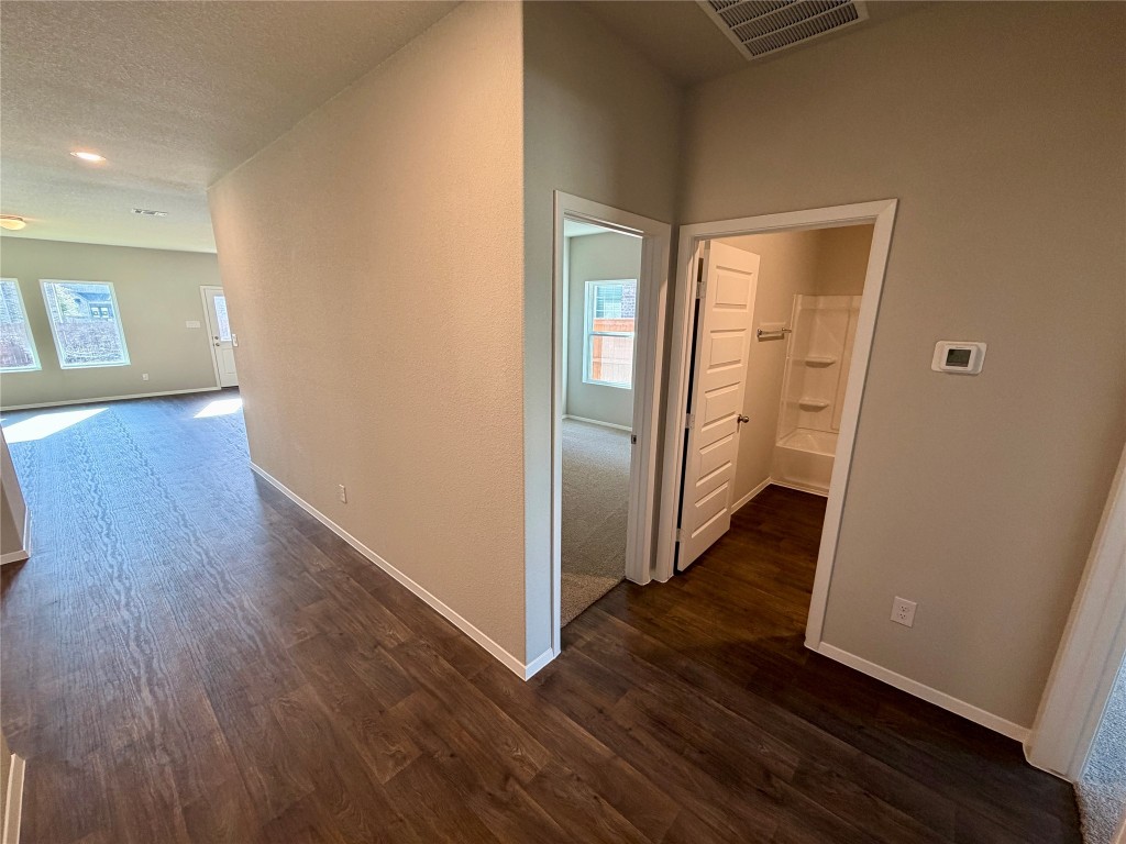 117 Rocky View Lane Georgetown, TX 78628 - Photo 7 of 17 wooden floor in an empty room with a window