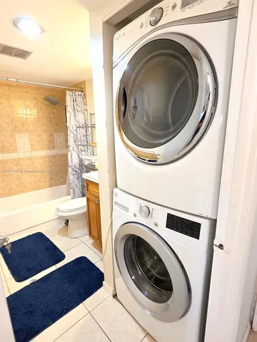 a living room with dryer and washer