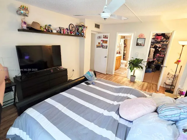 a bedroom with furniture and a flat screen tv