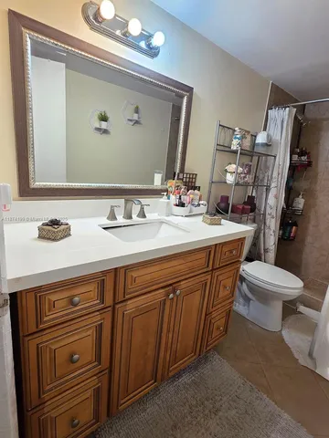 a bathroom with a sink a toilet and mirror