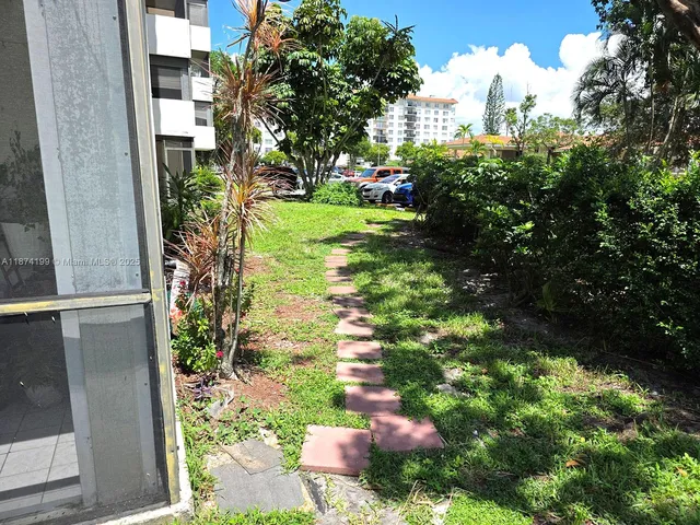 a backyard of a house with a garden and plants
