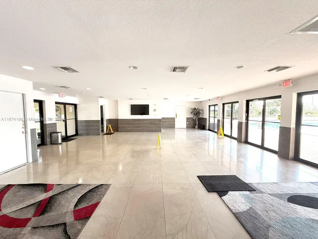 a lobby with furniture and floor to ceiling window