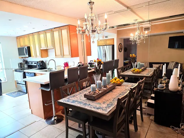 a dining room with furniture and a chandelier