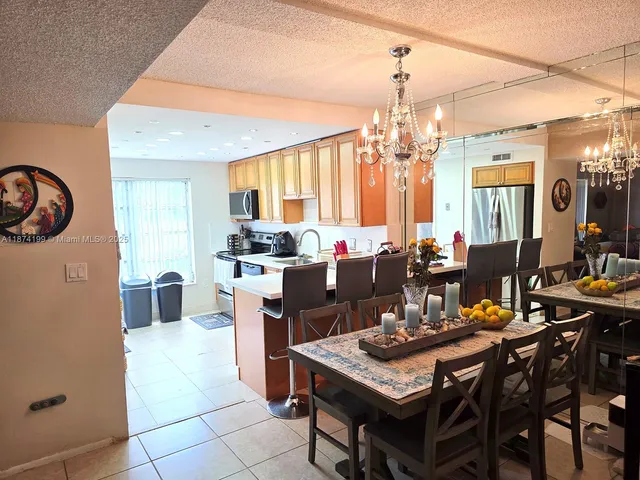a view of a dining room with furniture and a chandelier