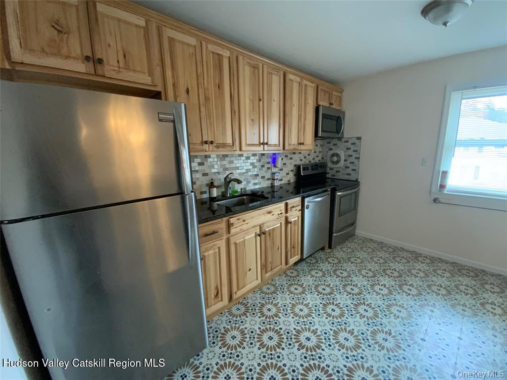 250 Beechwood Avenue Poughkeepsie, NY 12601 - Photo 3 of 7 a kitchen with stainless steel appliances granite countertop a refrigerator and a sink