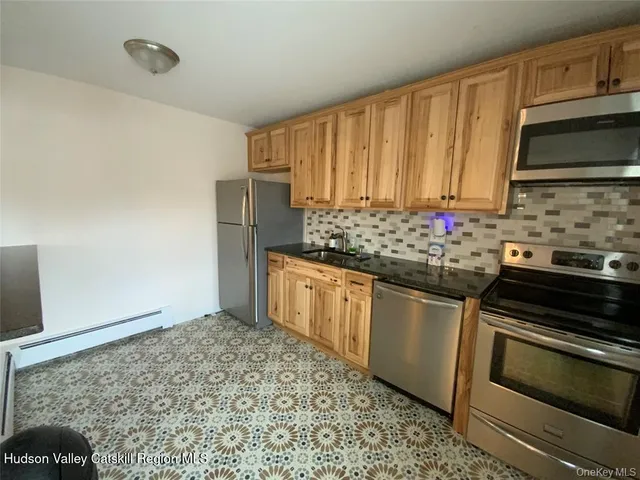 a kitchen with stainless steel appliances a stove a sink and a microwave