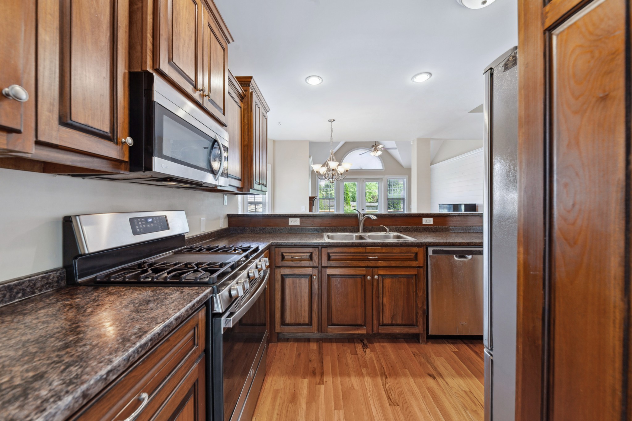 1093 Golf View Way Spring Hill, TN 37174 - Photo 8 of 46 a kitchen with stainless steel appliances granite countertop a stove and a sink
