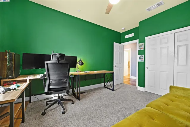 a view of a workspace with furniture and a backyard