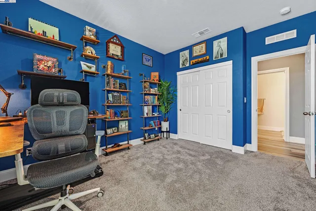 a living room with furniture and a book shelf