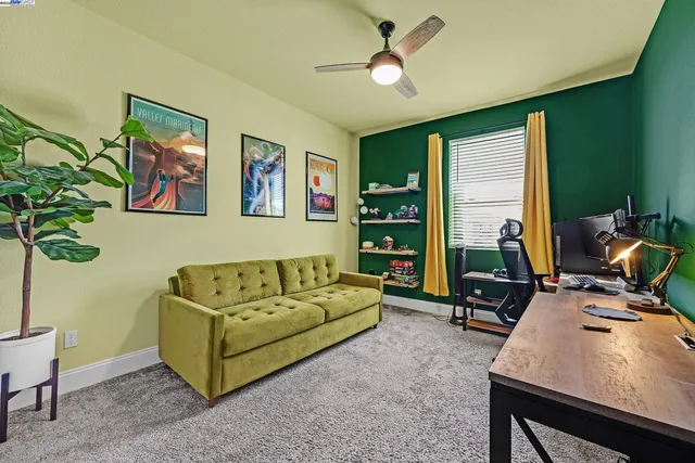 a living room with furniture gym equipment and a window