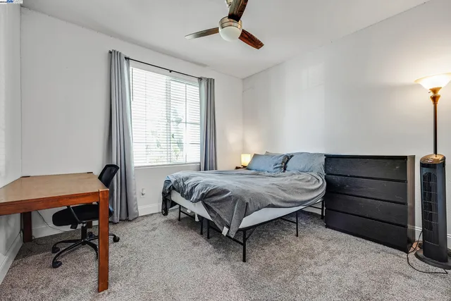 a bedroom with a bed and a desk