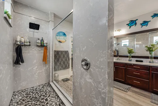 a bathroom with a sink a mirror and shower