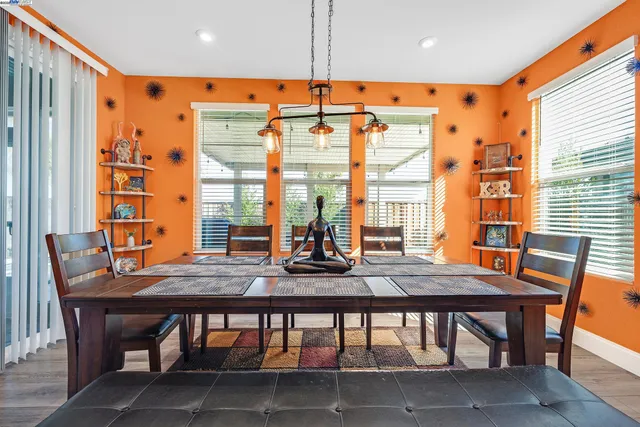 a view of a dining room with furniture large windows and wooden floor