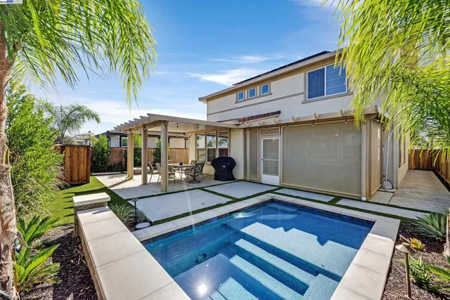 a view of backyard with outdoor seating and plants