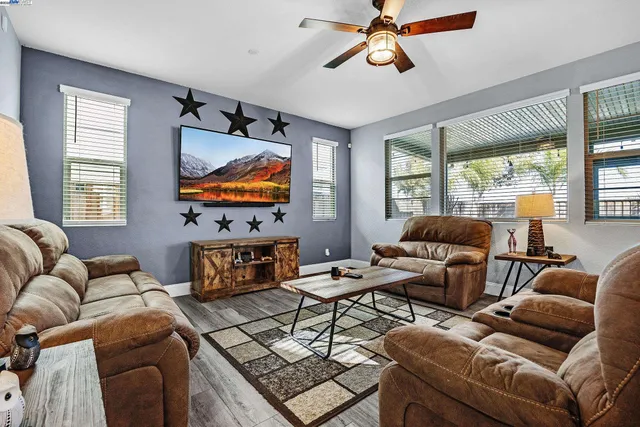 a living room with furniture a window and a flat screen tv