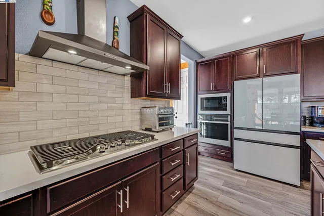 a kitchen with wooden cabinets and a stove top oven