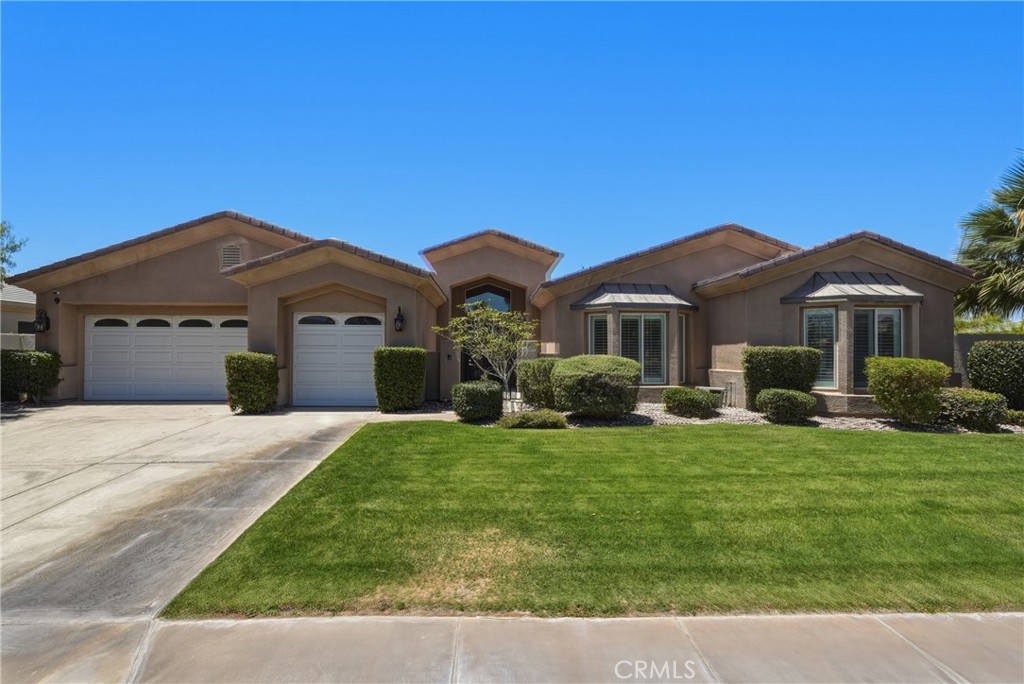 9 Orleans Road Rancho Mirage, CA 92270 - Photo 1 of 71 a front view of a house with a garden