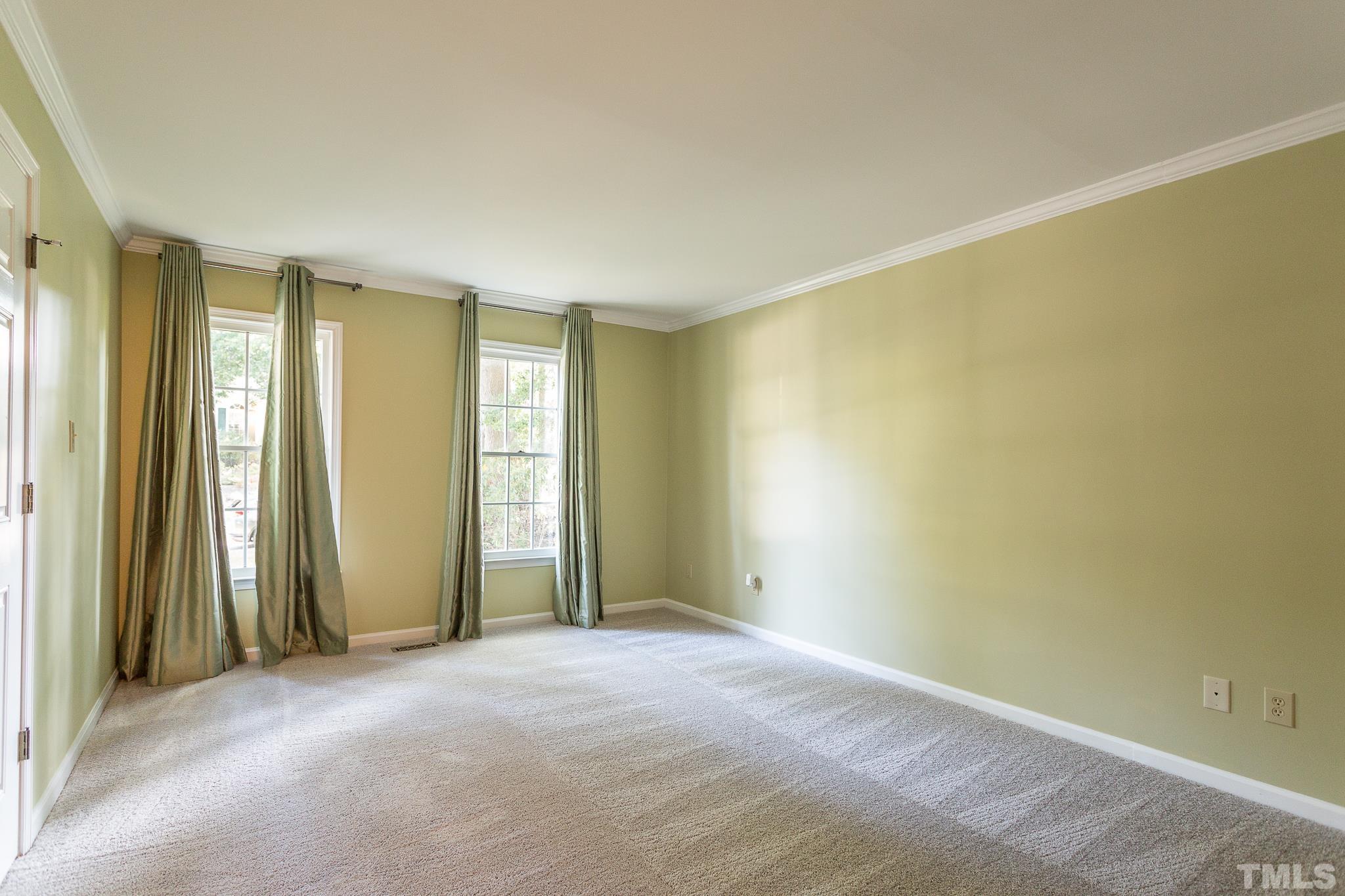 1200 Oakside Court Raleigh, NC 27609 - Photo 12 of 28 an empty room with large window and a ceiling fan