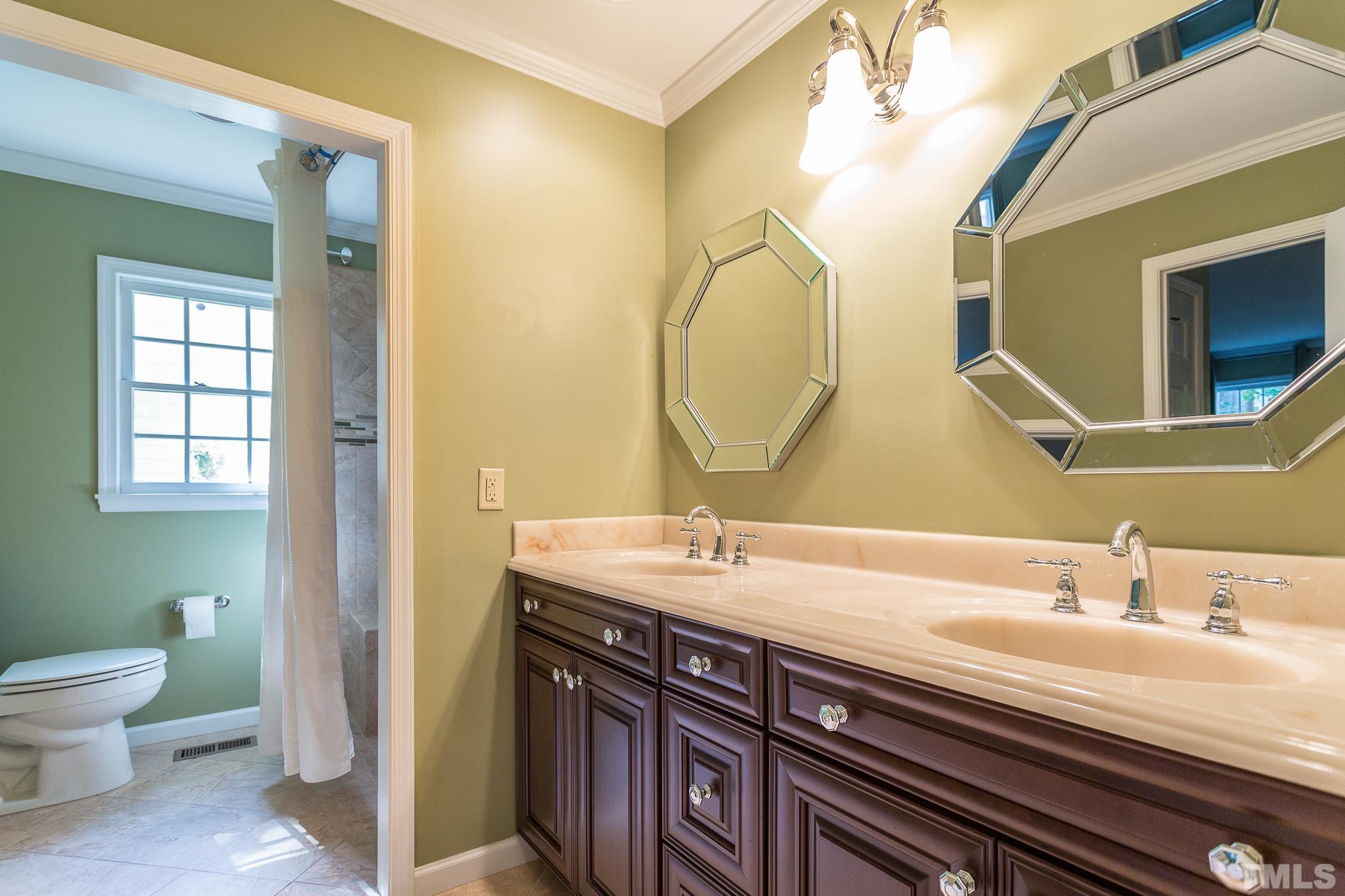 1200 Oakside Court Raleigh, NC 27609 - Photo 14 of 28 a bathroom with a granite countertop toilet sink and mirror