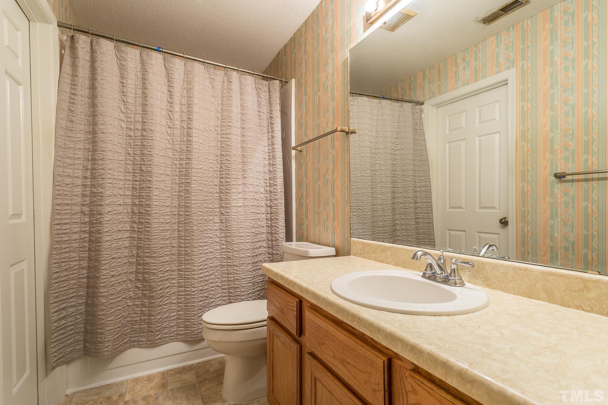 1200 Oakside Court Raleigh, NC 27609 - Photo 17 of 28 a bathroom with a granite countertop sink toilet and a mirror