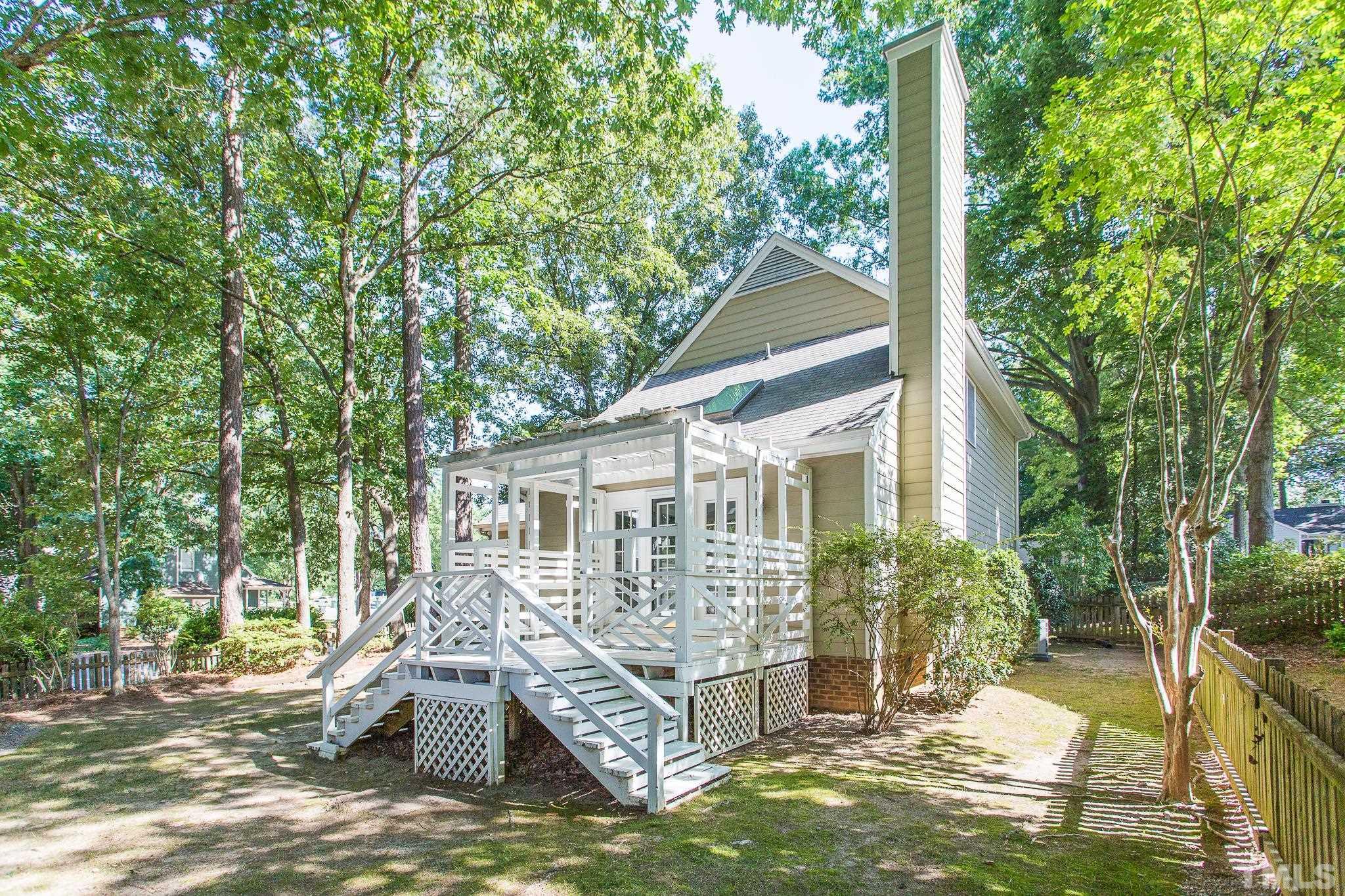 1200 Oakside Court Raleigh, NC 27609 - Photo 24 of 28 a front view of a house with a yard table and chairs