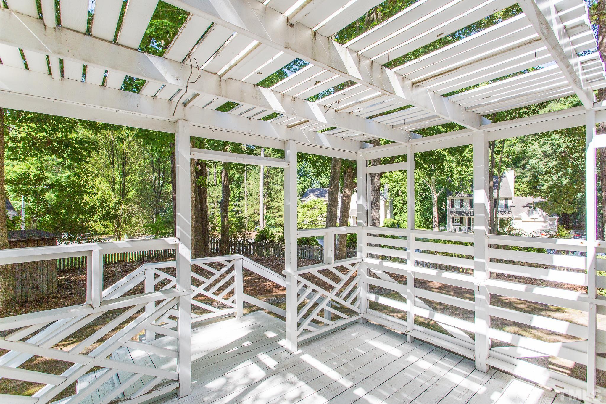 1200 Oakside Court Raleigh, NC 27609 - Photo 26 of 28 a view of a patio with a tv outdoor seating and a garden
