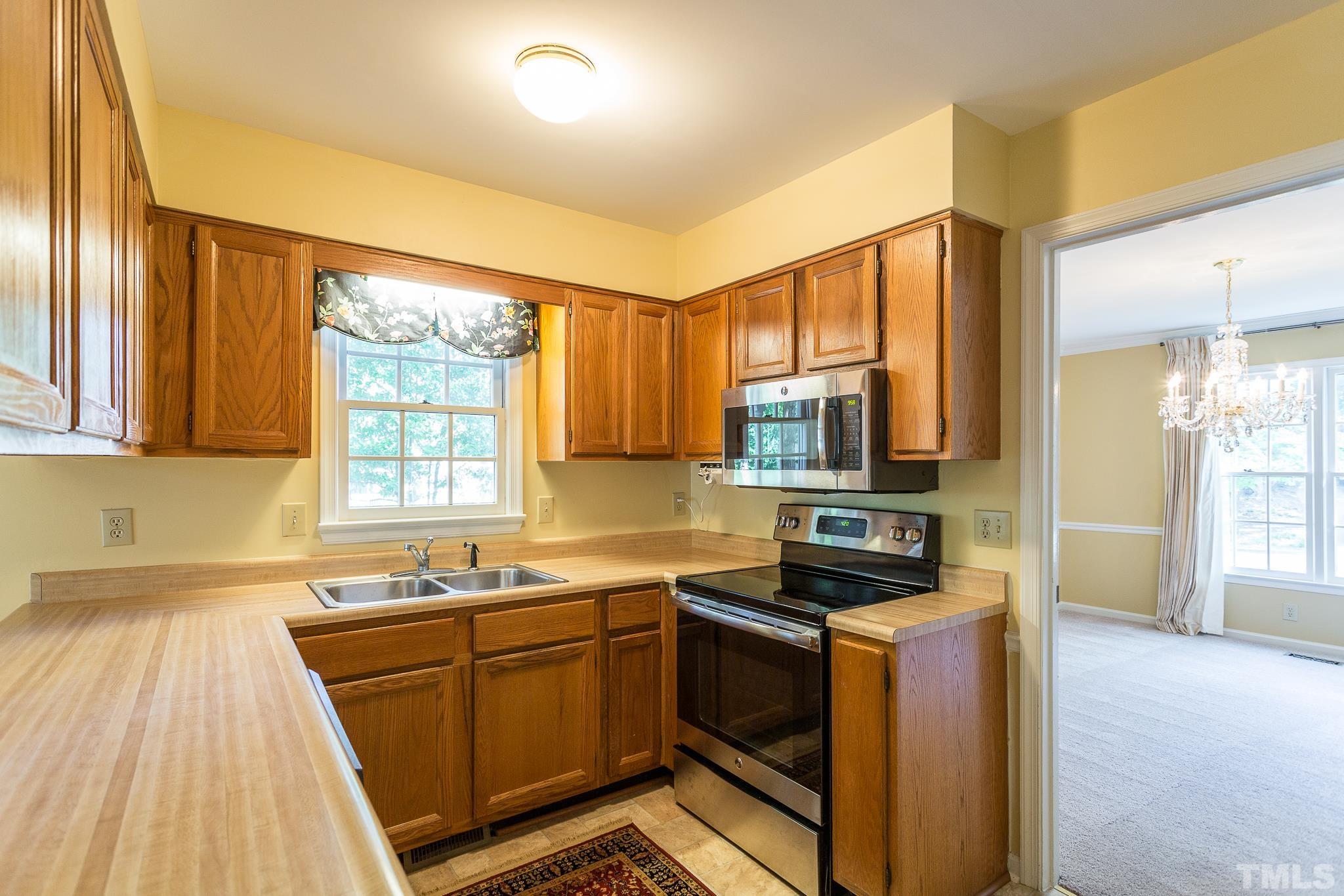 1200 Oakside Court Raleigh, NC 27609 - Photo 7 of 28 a kitchen that has a sink and a stove in it