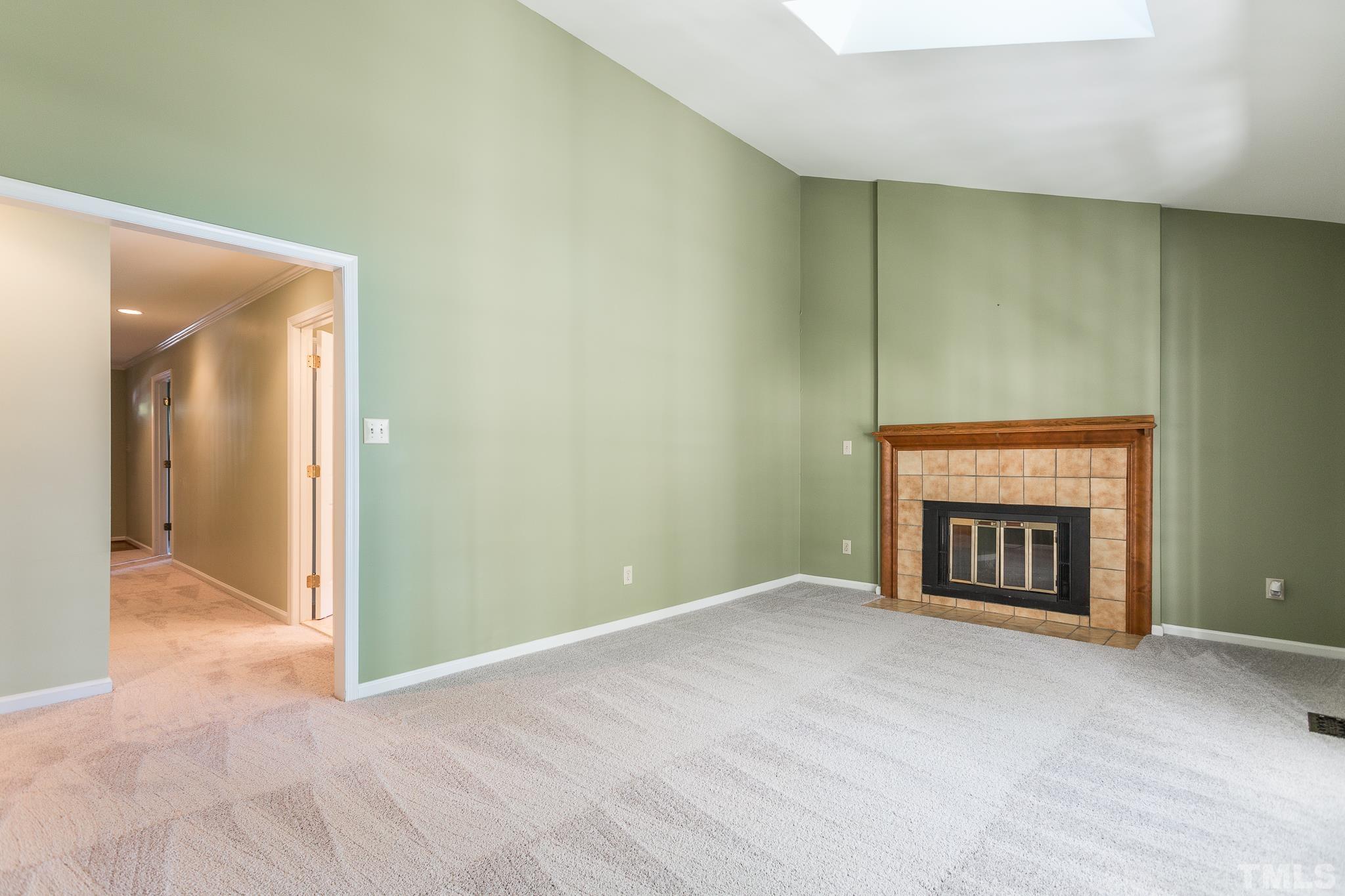 1200 Oakside Court Raleigh, NC 27609 - Photo 9 of 28 a view of an empty room with a fireplace and a window