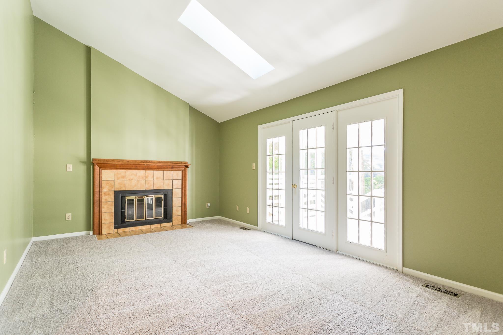 1200 Oakside Court Raleigh, NC 27609 - Photo 10 of 28 a view of an empty room with a window and a fireplace