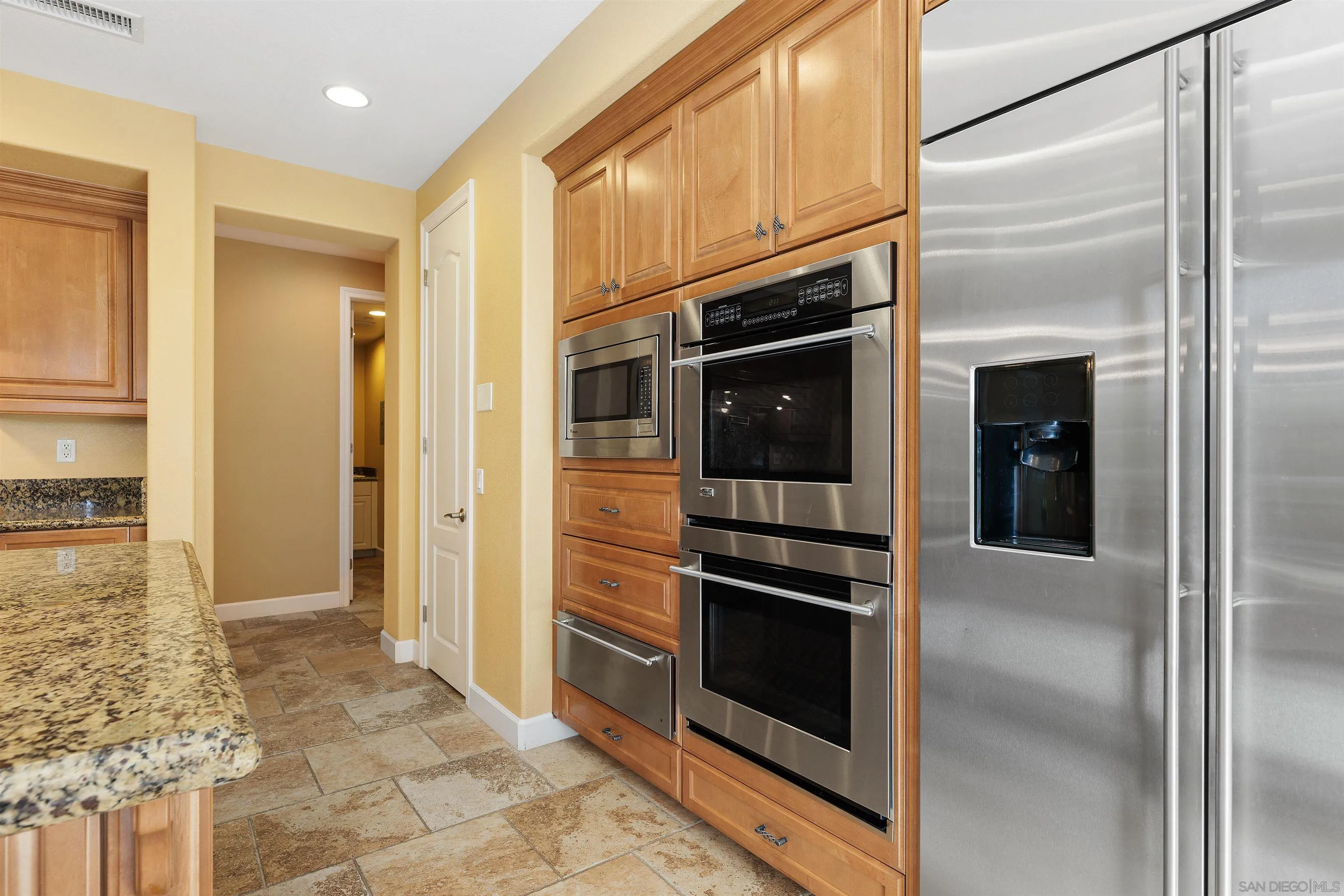527 Quail Pointe Lane Encinitas, CA 92024 - Photo 20 of 46 a kitchen with a refrigerator and an oven