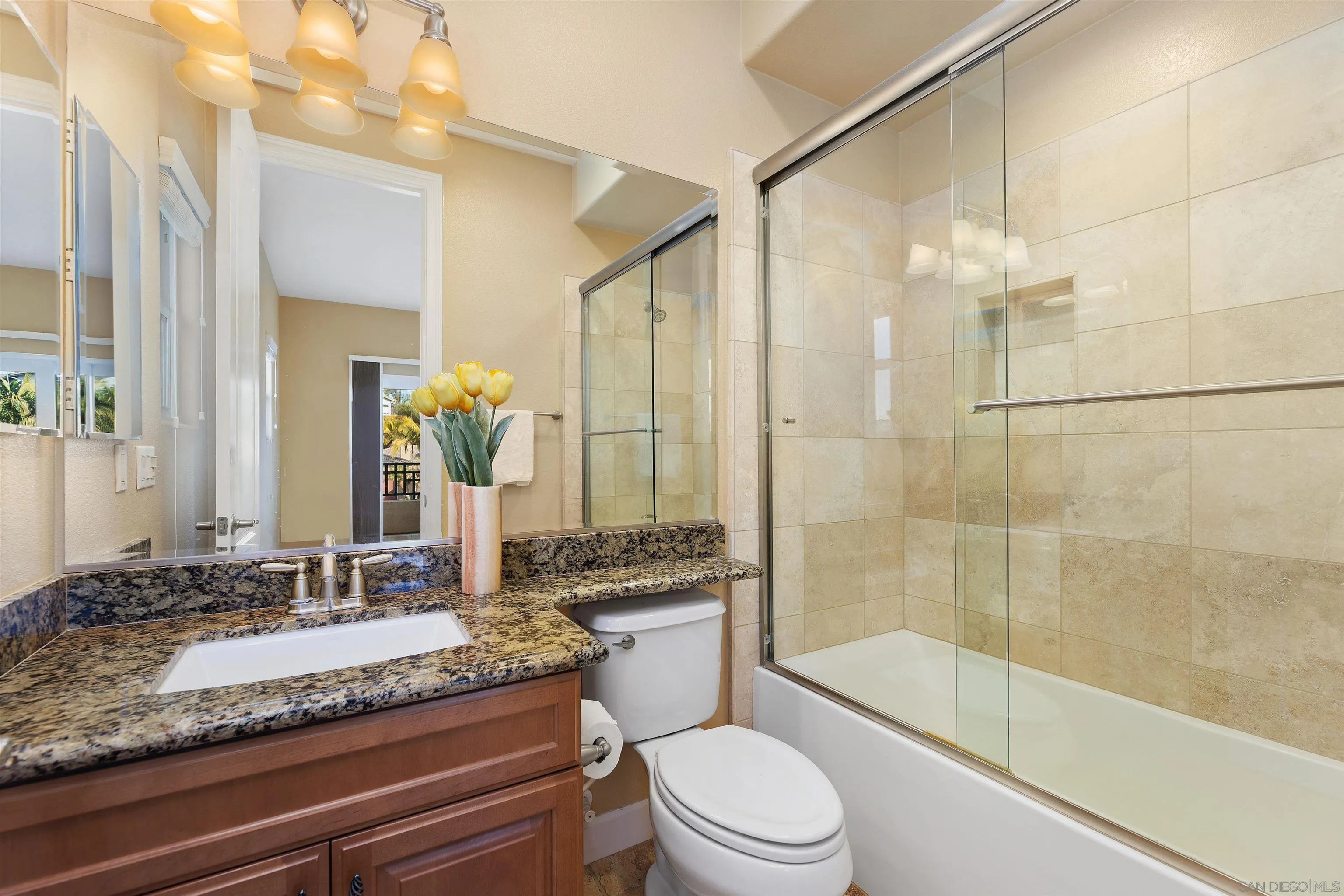 527 Quail Pointe Lane Encinitas, CA 92024 - Photo 35 of 46 a bathroom with a granite countertop sink a toilet and shower