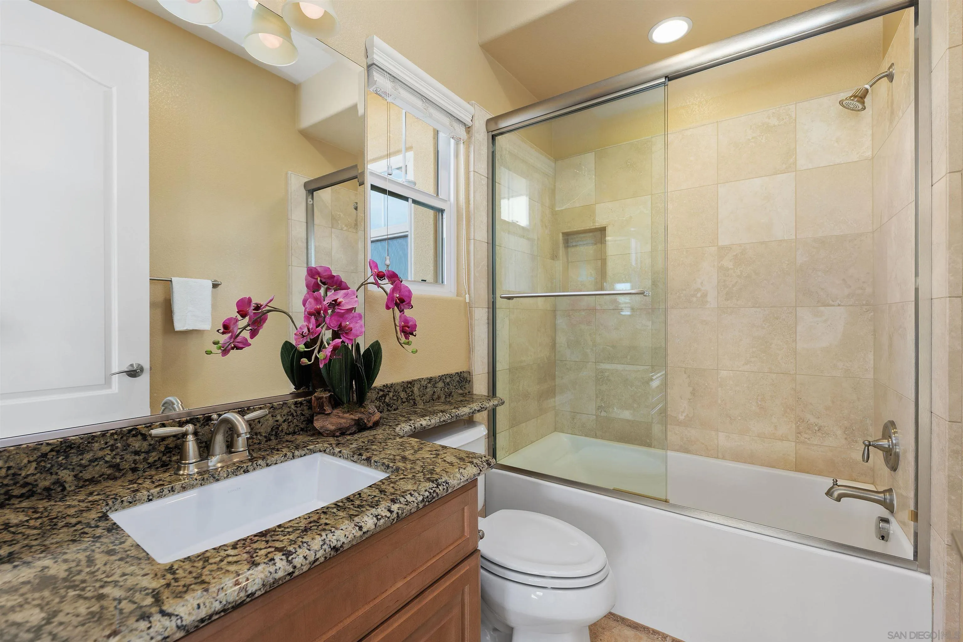 527 Quail Pointe Lane Encinitas, CA 92024 - Photo 37 of 46 a bathroom with a granite countertop sink a toilet and shower