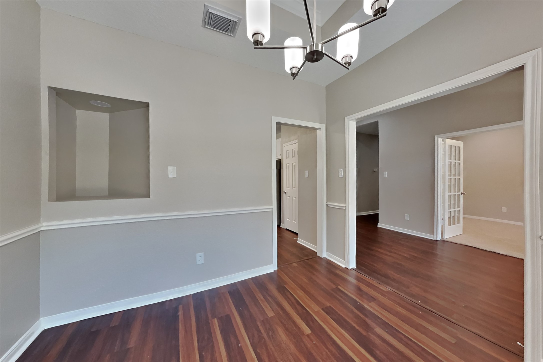 8615 Mile Run Road Humble, TX 77346 - Photo 4 of 19 wooden floor in an empty room with a window