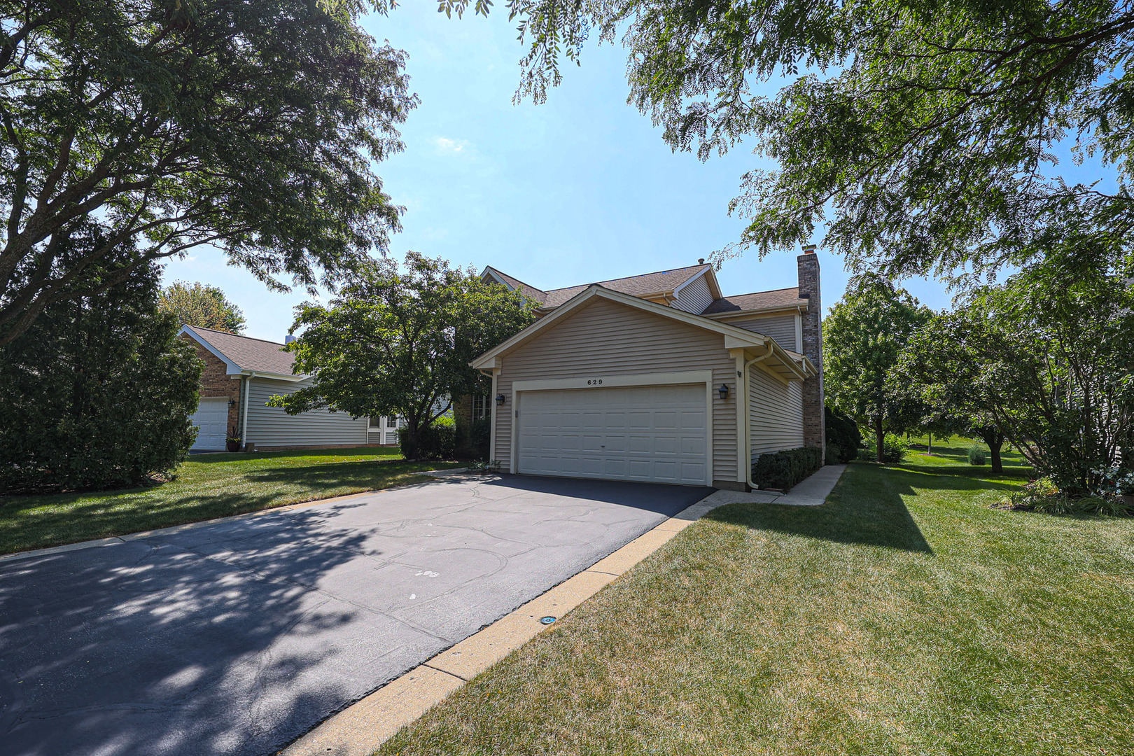 629 Dogleg Lane Bartlett, IL 60103 - Photo 1 of 37 a front view of a house with a yard and garage