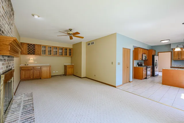 a view of a livingroom with furniture and a ceiling fan