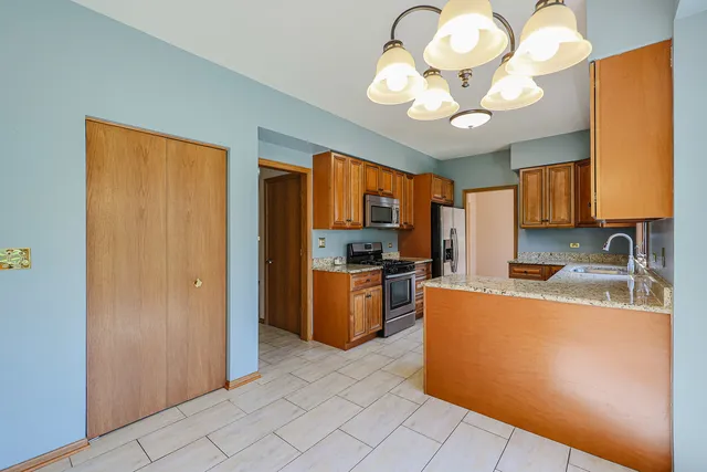 a kitchen with stainless steel appliances granite countertop a sink counter space cabinets and stainless steel appliances