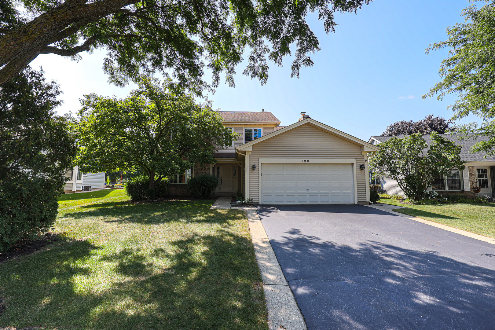 629 Dogleg Lane Bartlett, IL 60103 - Photo 2 of 37 a view of a house with a yard and tree