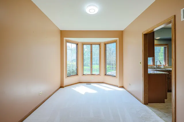 a view of a big room with a large window and front door