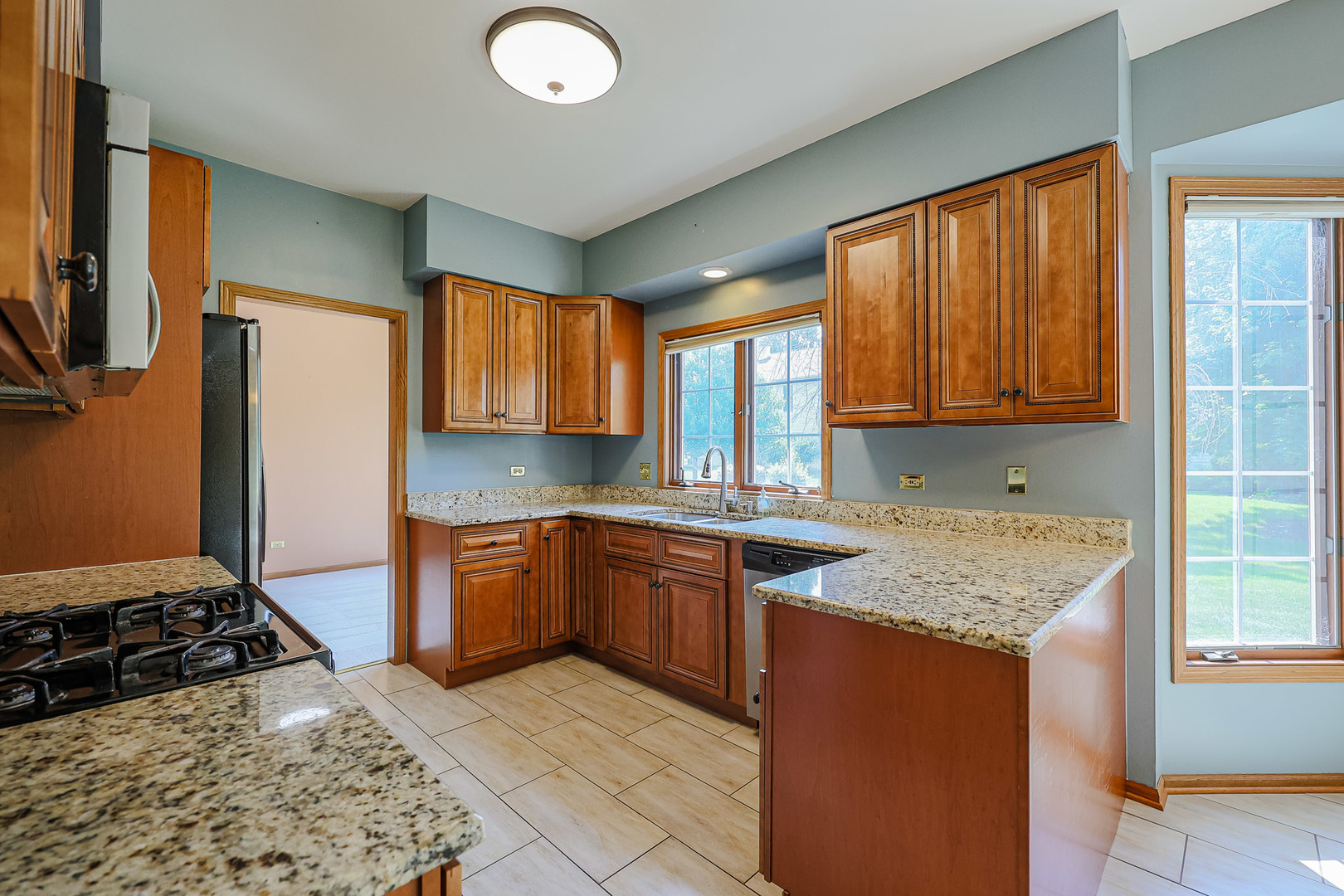 629 Dogleg Lane Bartlett, IL 60103 - Photo 8 of 37 a kitchen with stainless steel appliances granite countertop a stove a sink dishwasher and a refrigerator