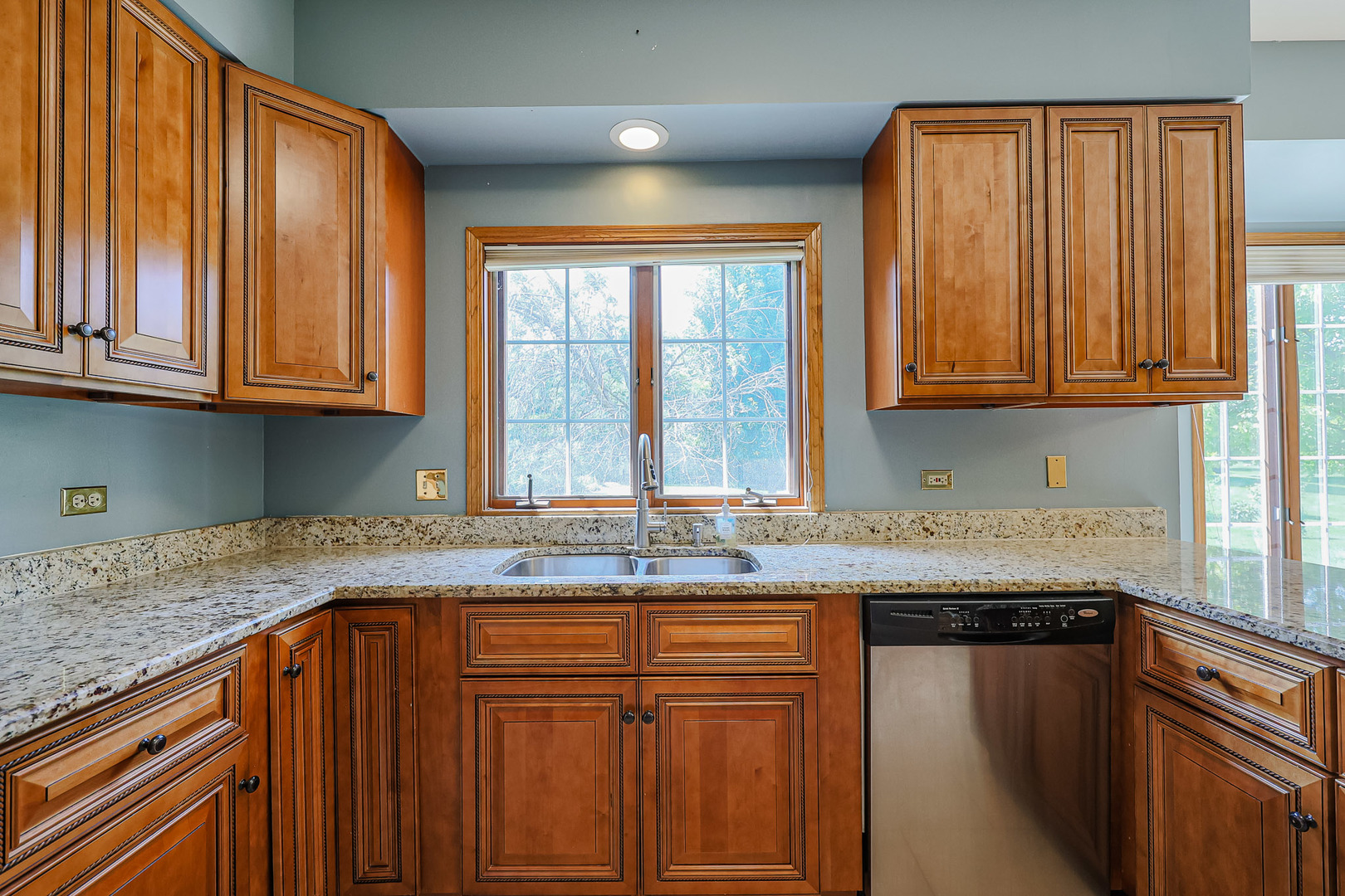 629 Dogleg Lane Bartlett, IL 60103 - Photo 9 of 37 a kitchen with granite countertop cabinets sink and window