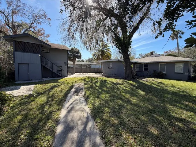 a view of house with yard