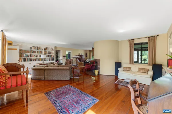 a living room with furniture a rug and a large window