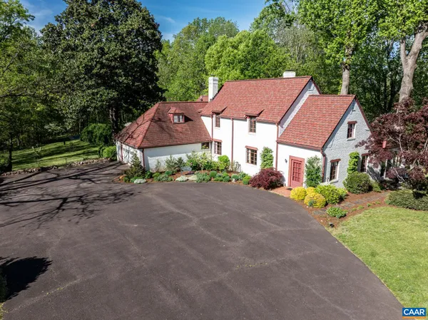 a aerial view of a house with a yard and a garage
